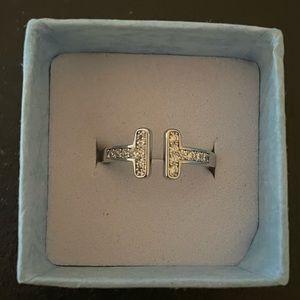 T ring with brilliant CZ. 18k white gold plated . Adjustable size 6-8